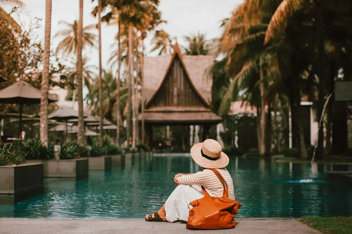 Blog podróżniczy — Anonymous female relaxing near calm rippling water of pond s